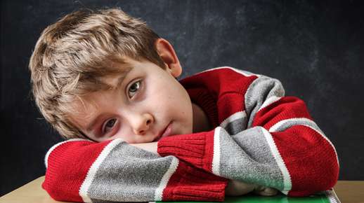 Child laying his head on his arms