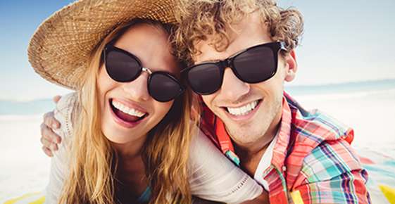 Woman and Man wearing Black Sunglasses at Beach