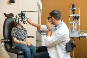 Eye doctor giving an eye exam