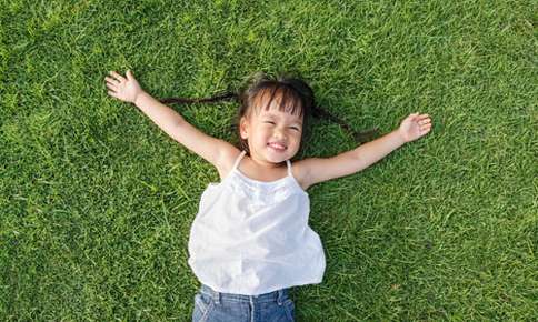 Child laying in the grass