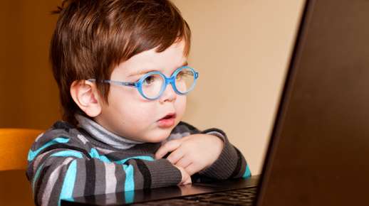 Toddler looking at a computer