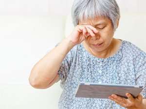 Older Woman rubbing her eye 