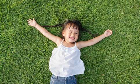 Child laying in the grass 
