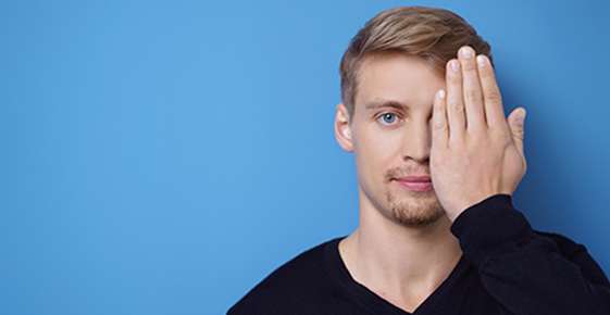 Man covering one eye