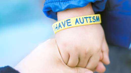 hand wearing autism bracelet