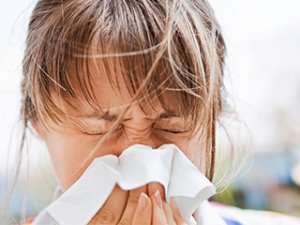 Woman blowing her nose