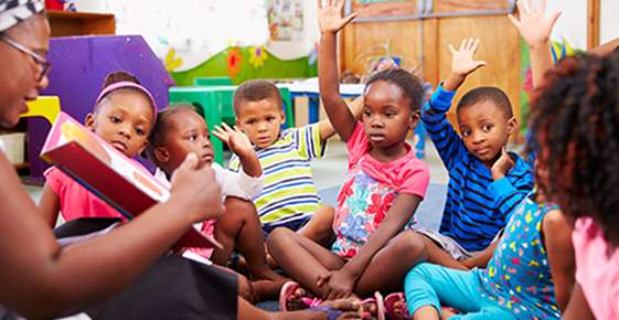 Children reading a book together